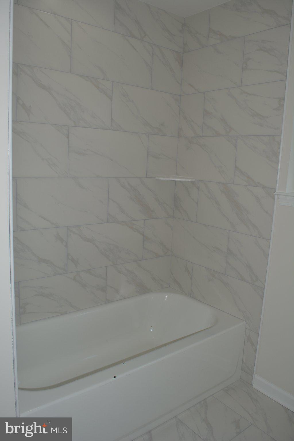7631 Ridge Avenue, Unit 2 Philadelphia, PA 19128 - Photo 11 of 16 Sleek marble-inspired bath retreat.