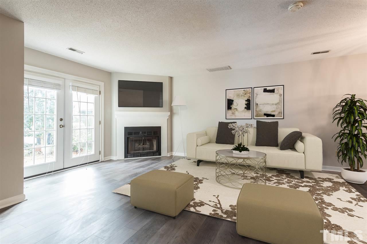 5630 Bridgetowne Way Raleigh, NC 27609 - Photo 3 of 26 a living room with furniture window and a fireplace