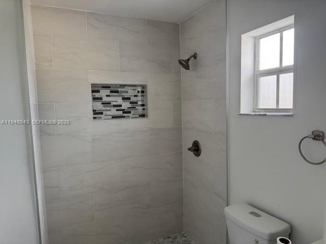 7625 Shalimar Street Miramar, FL 33023 - Photo 21 of 38 a bathroom with a shower toilet and a window