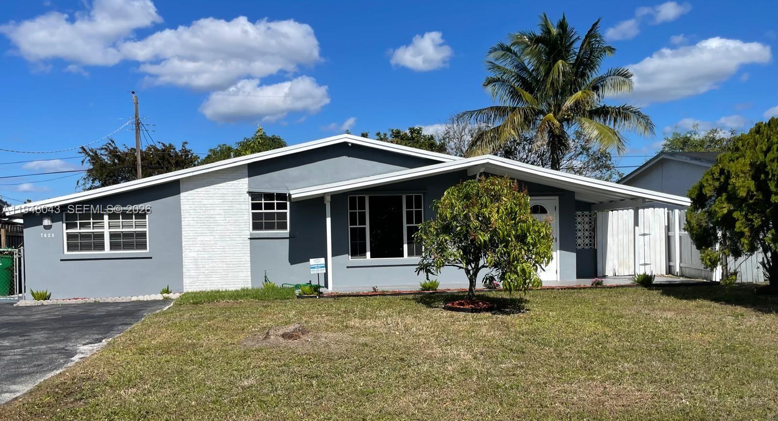 7625 Shalimar Street Miramar, FL 33023 - Photo 3 of 38 a front view of a house with a garden