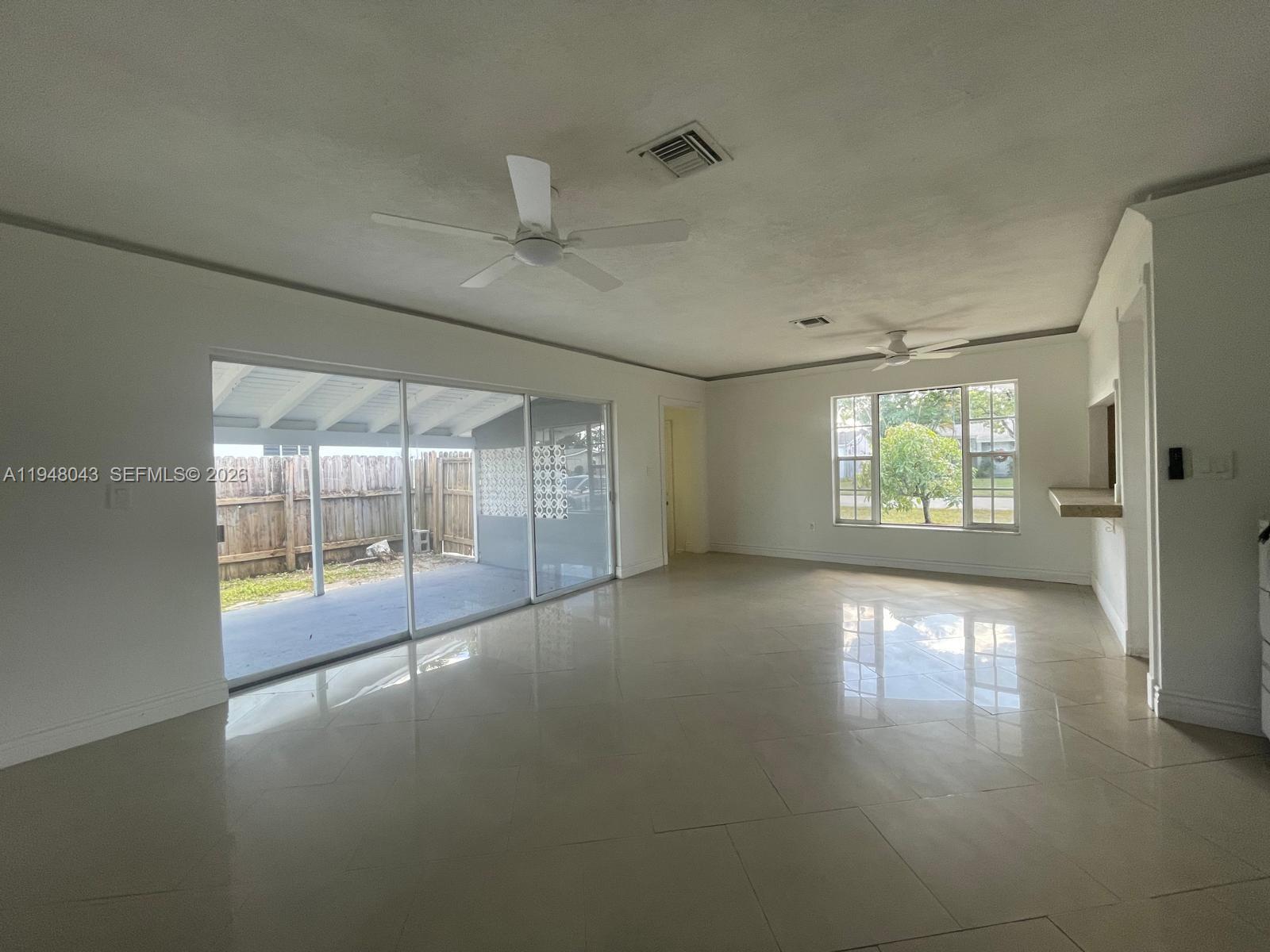 7625 Shalimar Street Miramar, FL 33023 - Photo 5 of 38 an empty room with floor to ceiling windows and windows