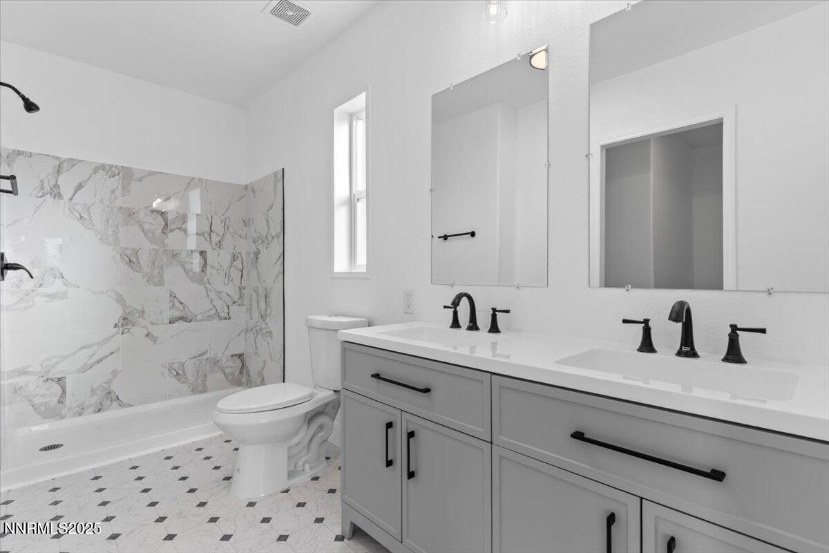 11305 Fir Drive Reno, NV 89506 - Photo 14 of 35 a bathroom with a sink a toilet and shower