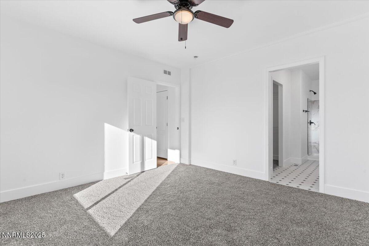 11305 Fir Drive Reno, NV 89506 - Photo 19 of 35 an empty room with chandelier fan and windows
