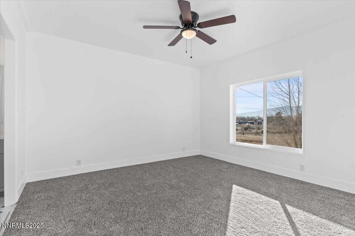 11305 Fir Drive Reno, NV 89506 - Photo 20 of 35 an empty room with a window and a fan
