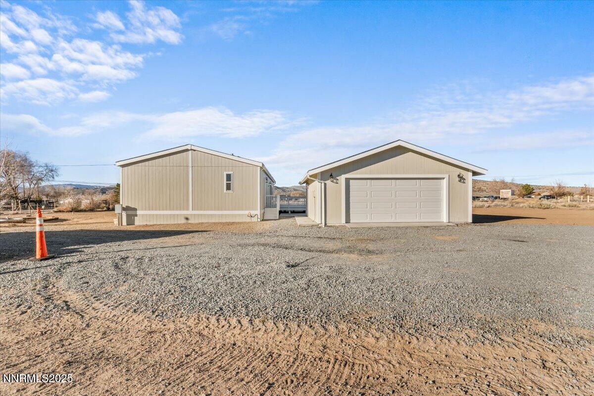 11305 Fir Drive Reno, NV 89506 - Photo 31 of 35 a front view of a house with a yard and garage