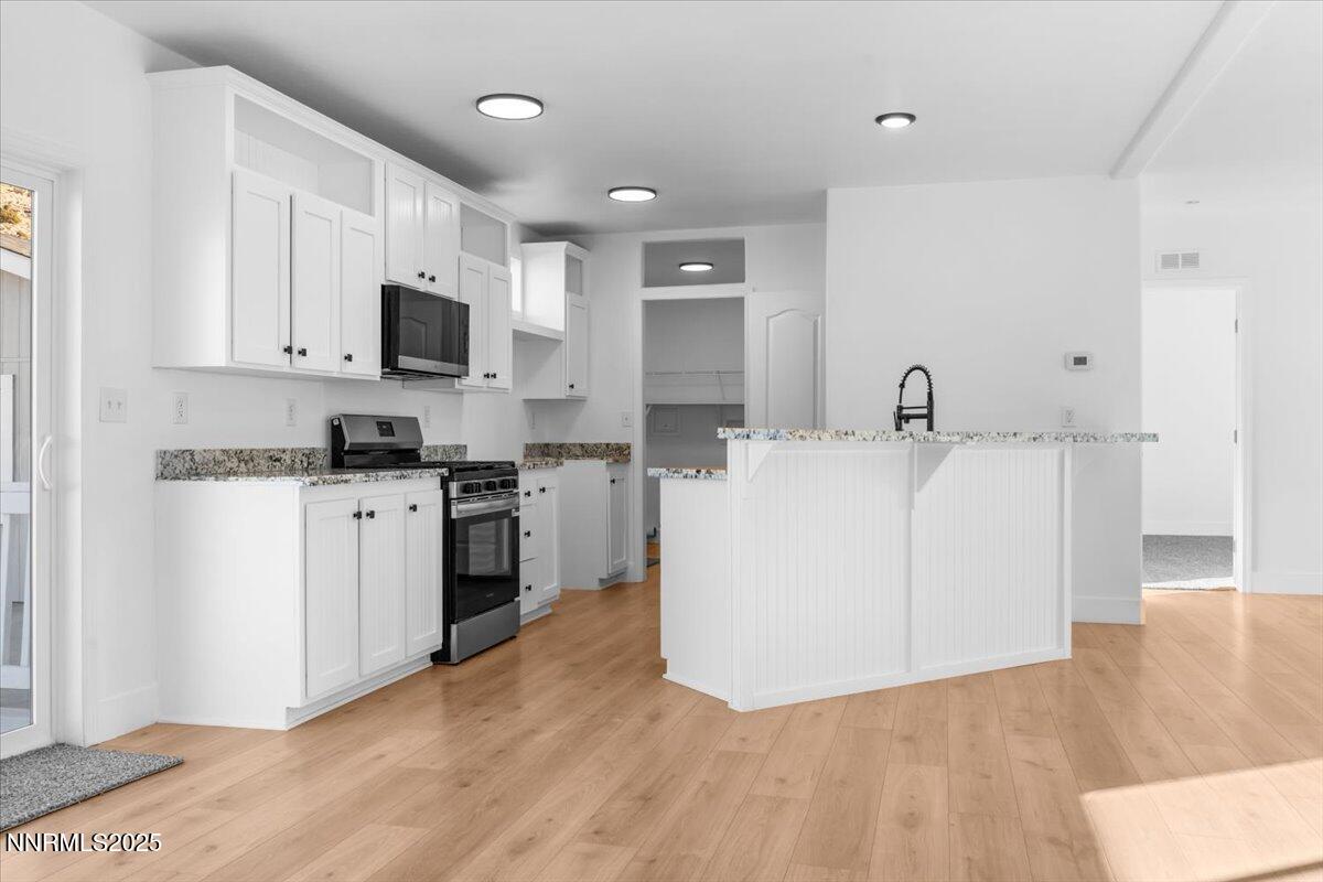 11305 Fir Drive Reno, NV 89506 - Photo 6 of 35 a view of kitchen with stainless steel appliances a sink and a microwave