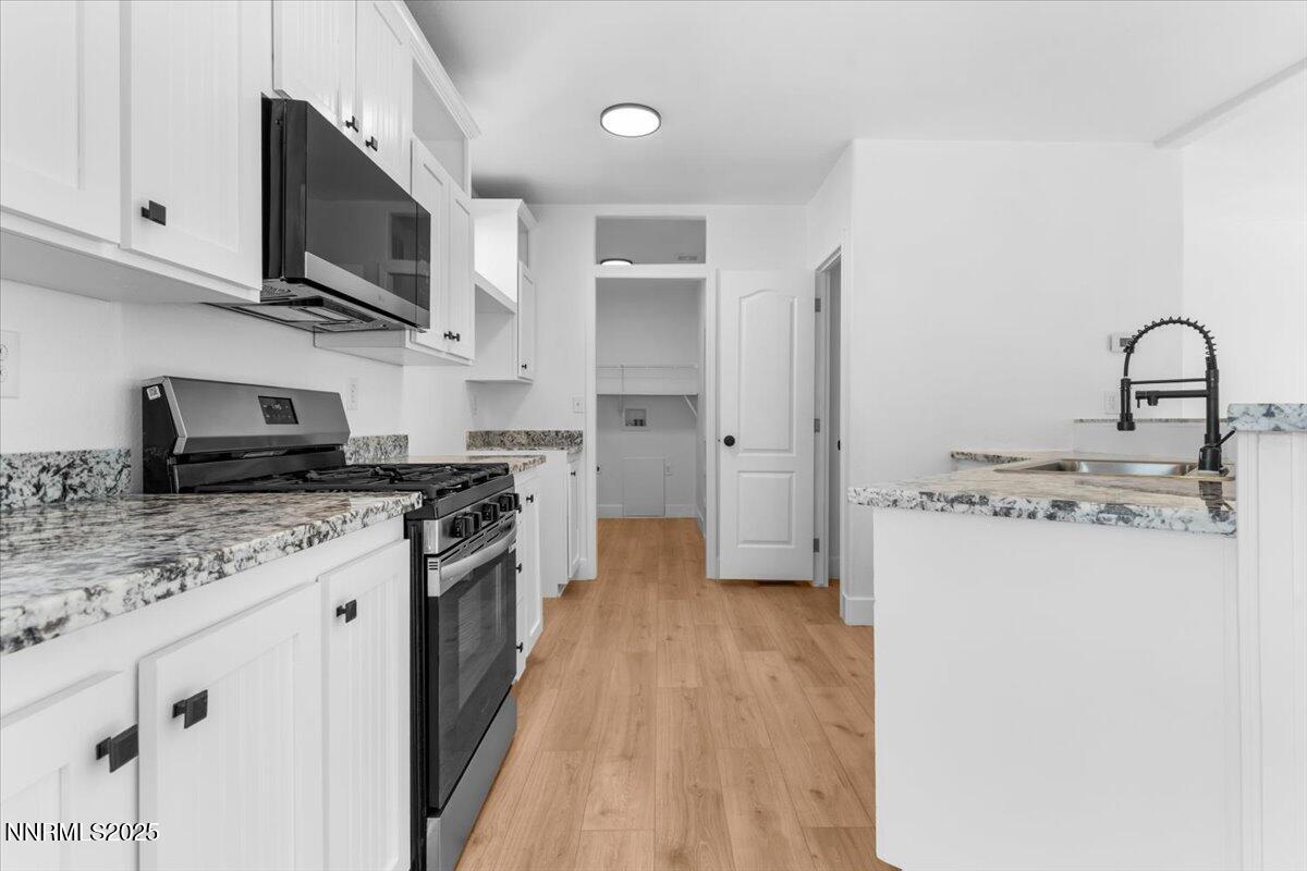 11305 Fir Drive Reno, NV 89506 - Photo 7 of 35 a kitchen with stainless steel appliances granite countertop a stove top oven a sink dishwasher and a refrigerator