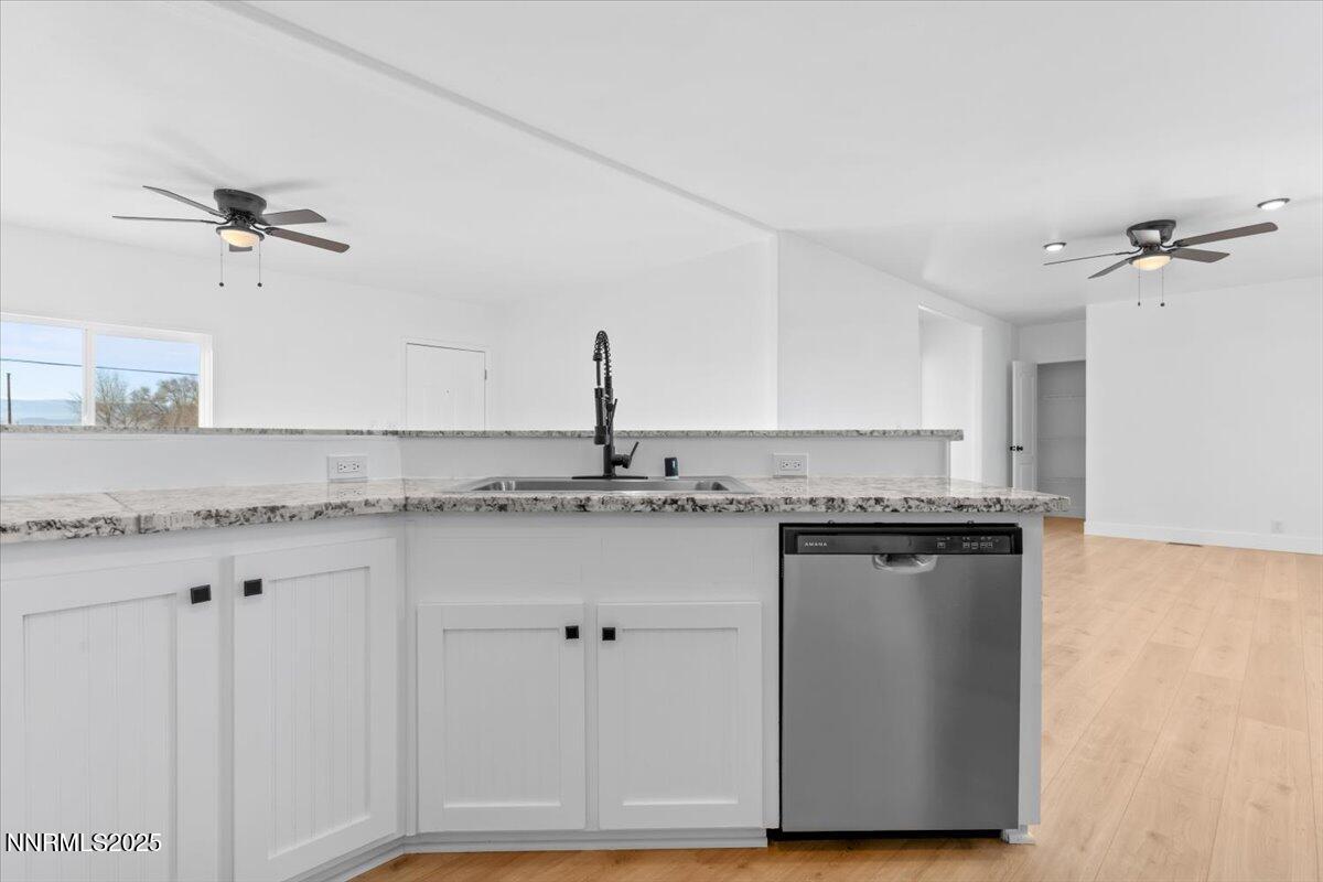 11305 Fir Drive Reno, NV 89506 - Photo 8 of 35 a kitchen with stainless steel appliances granite countertop a sink and a refrigerator