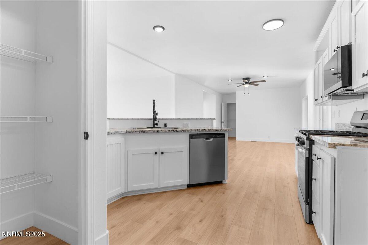 11305 Fir Drive Reno, NV 89506 - Photo 9 of 35 a view of a kitchen with a sink stove cabinets and empty room