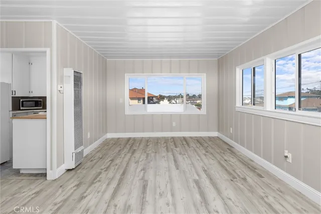 a kitchen with stainless steel appliances a refrigerator a stove a sink and white cabinets