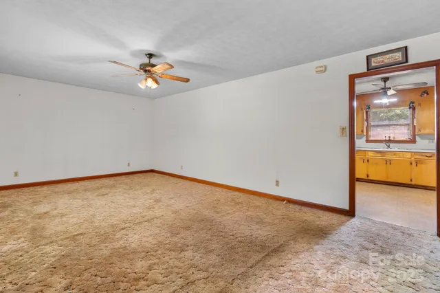a view of empty room with ceiling fan