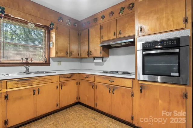 a kitchen with stainless steel appliances granite countertop a sink and cabinets