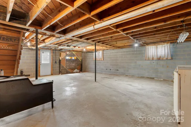 a view of empty room with wooden ceiling