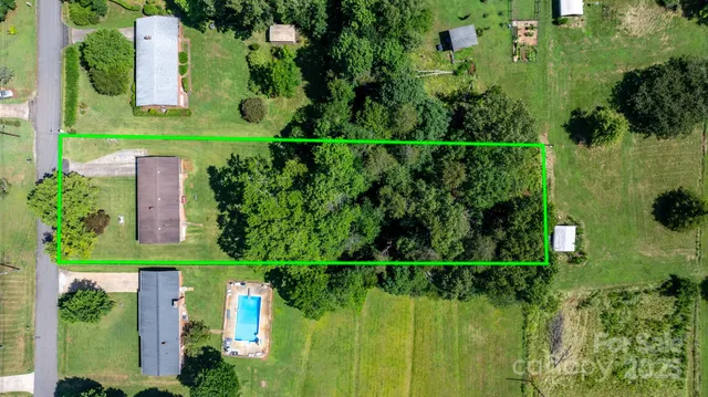 an aerial view of a houses with a yard