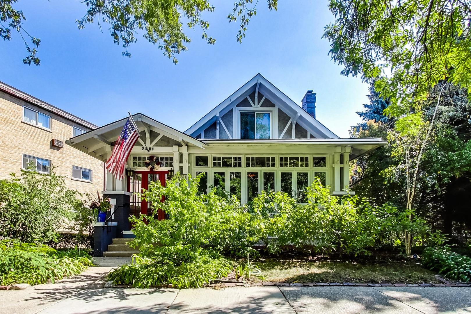 7221 North Ridge Boulevard Chicago, IL 60645 - Photo 1 of 48 a front view of a house with a yard and potted plants