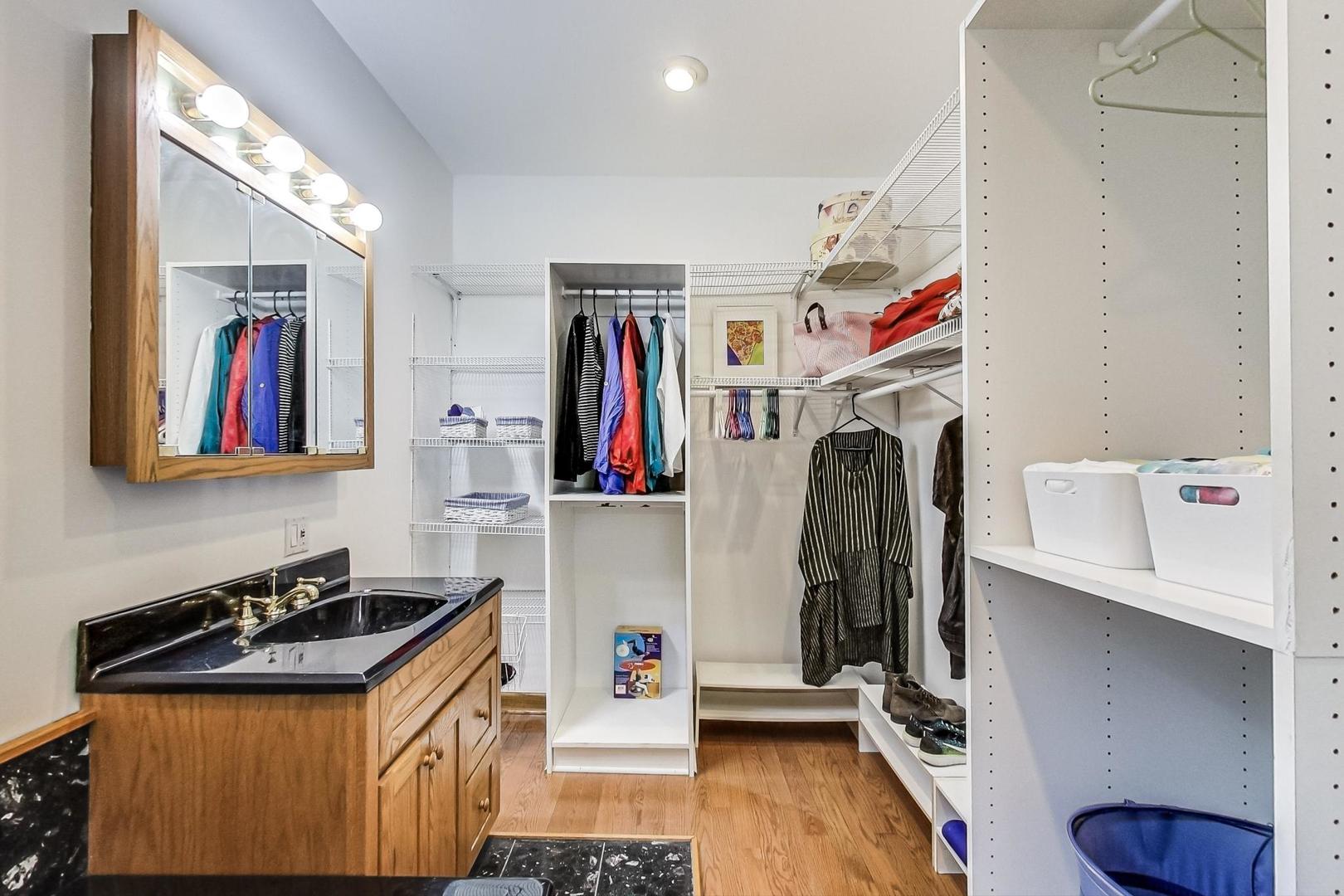 7221 North Ridge Boulevard Chicago, IL 60645 - Photo 23 of 48 a view of walk in closet with clothes and shoes