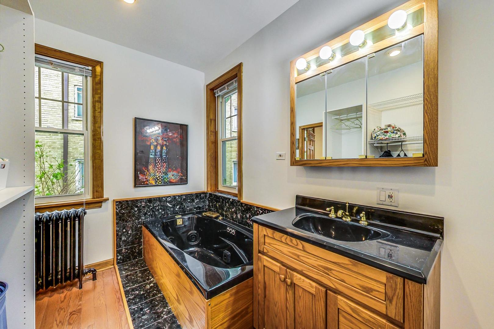7221 North Ridge Boulevard Chicago, IL 60645 - Photo 24 of 48 a kitchen with wooden cabinets and a stove top oven
