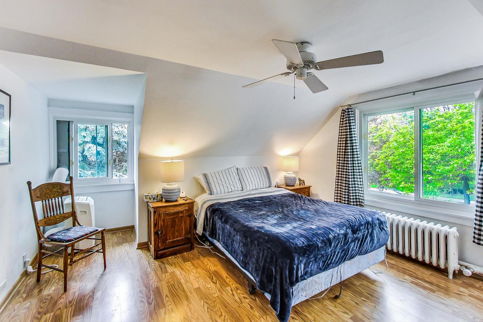 7221 North Ridge Boulevard Chicago, IL 60645 - Photo 26 of 48 a bedroom with a bed and a chair