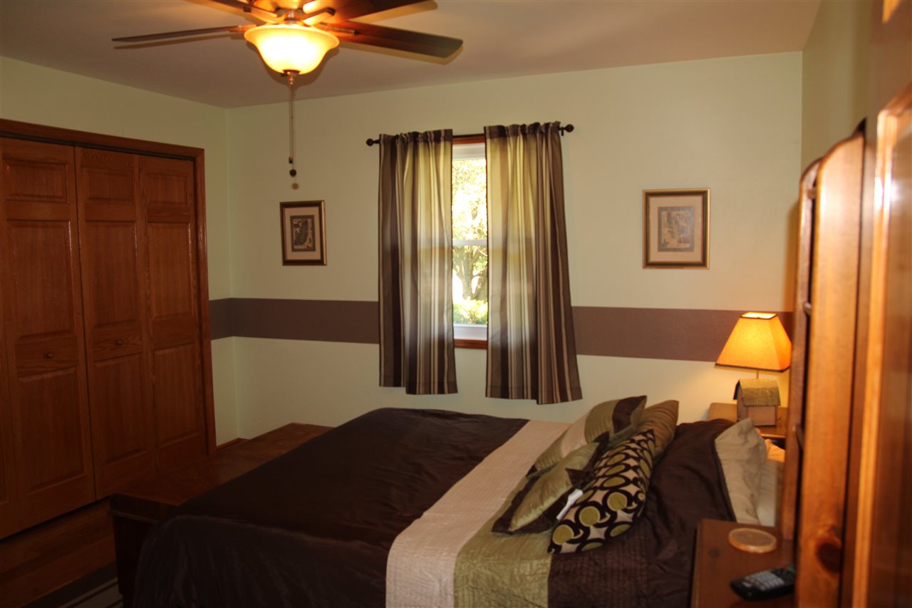 2711 Karr Road Belvidere, IL 61008 - Photo 11 of 17 a bedroom with a bed and a chandelier