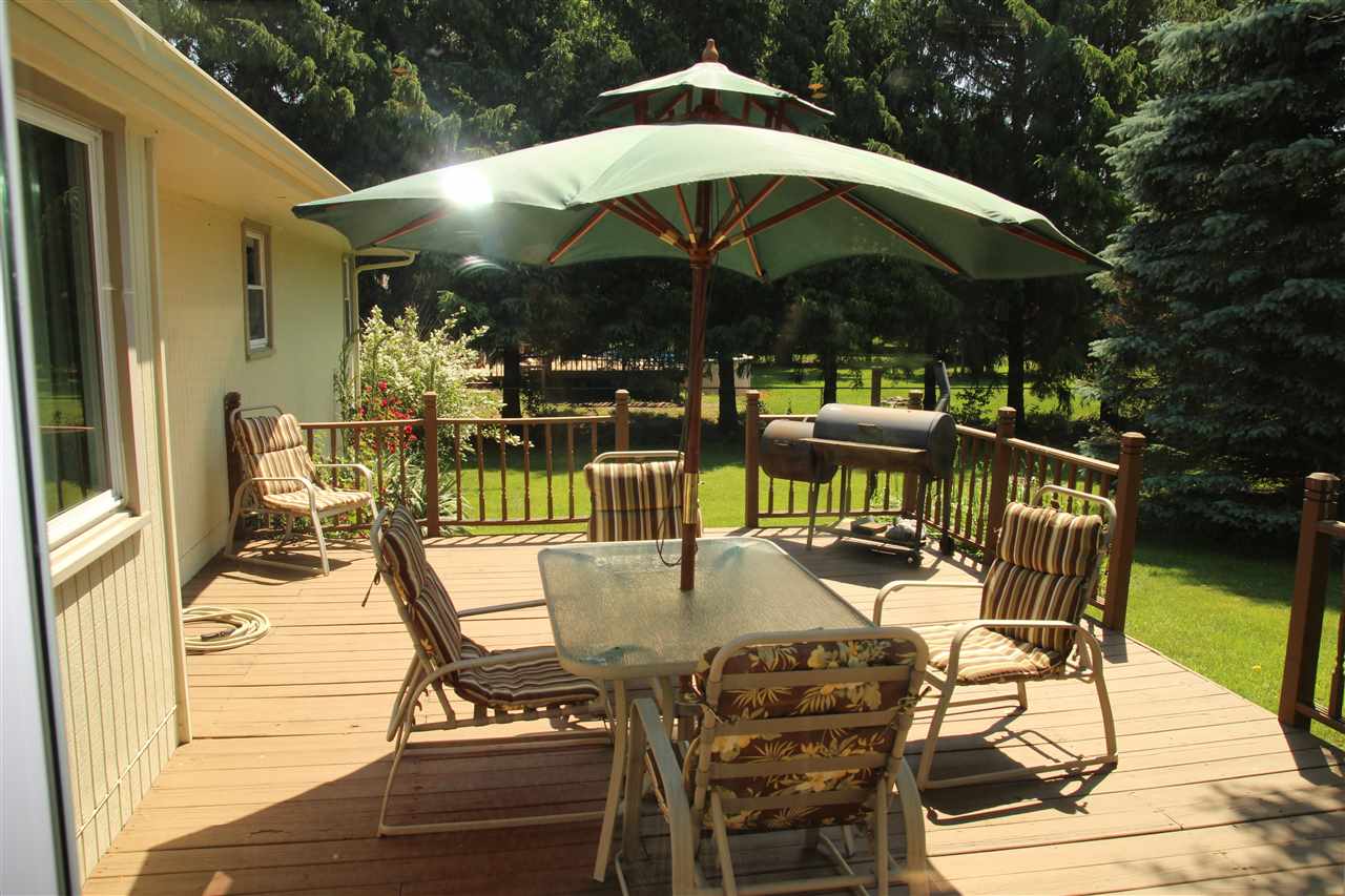 2711 Karr Road Belvidere, IL 61008 - Photo 14 of 17 a view of a patio with furniture and table under an umbrella