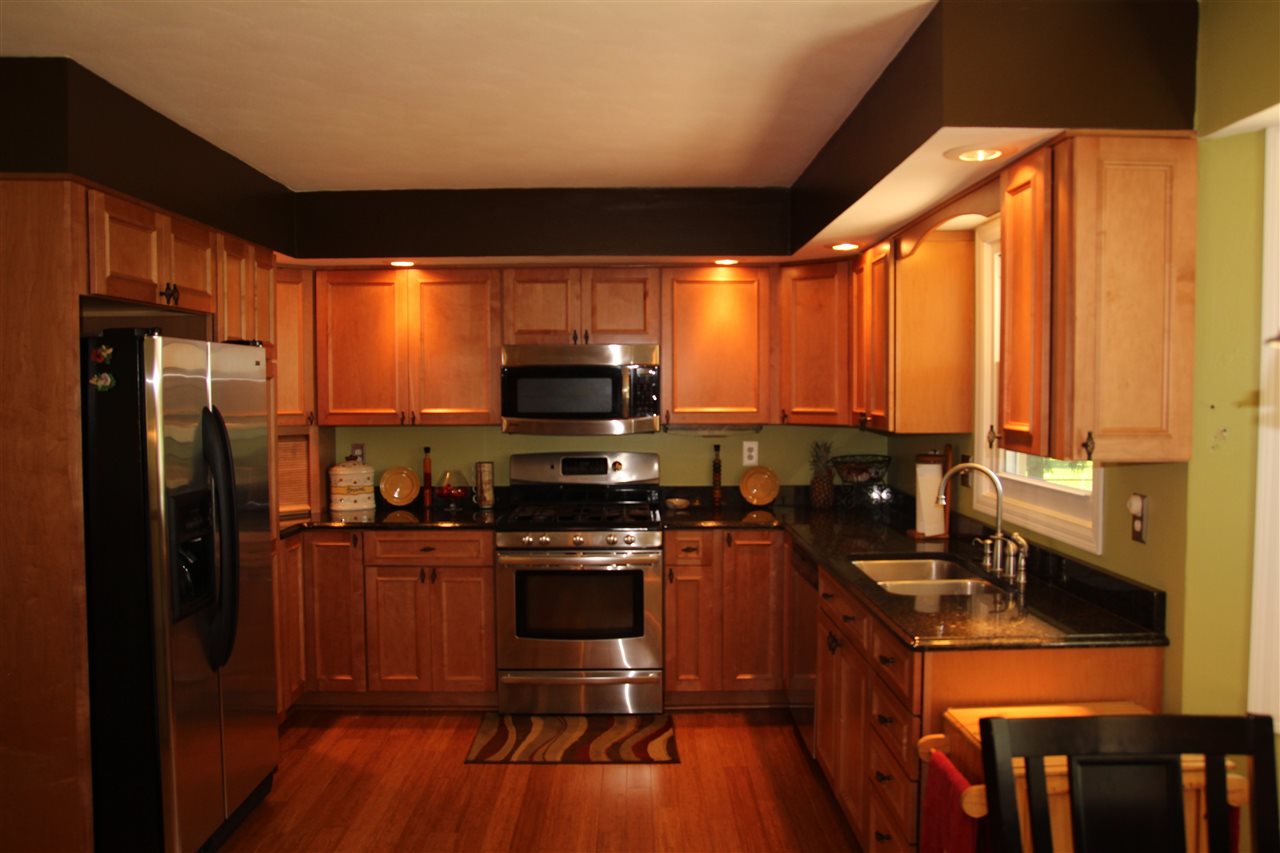 2711 Karr Road Belvidere, IL 61008 - Photo 4 of 17 a kitchen with stainless steel appliances a stove sink and refrigerator
