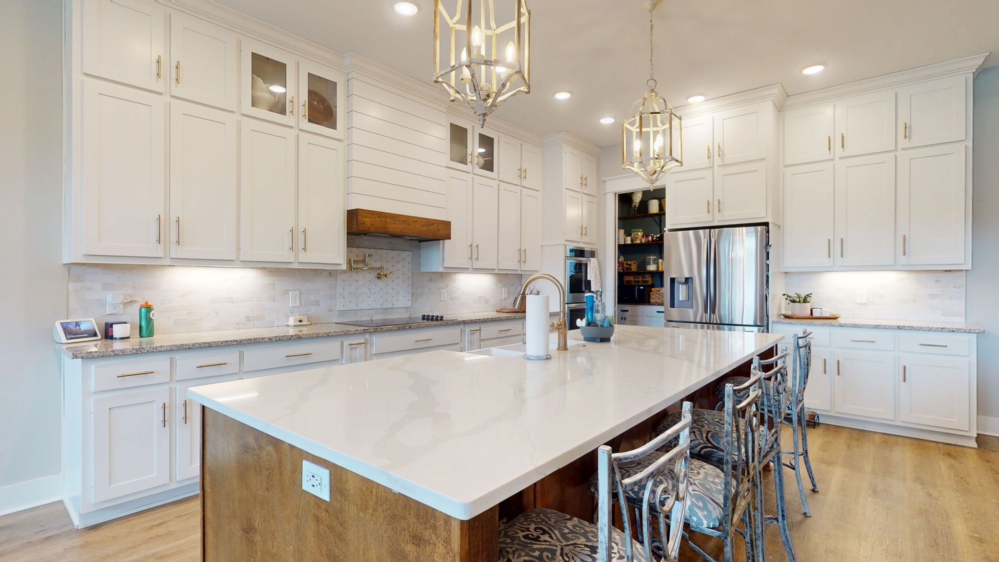 5130 Midland Road Christiana, TN 37037 - Photo 8 of 51 a kitchen with kitchen island a stove a sink a refrigerator and white cabinets with wooden floor