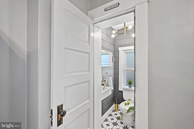 a bathroom with a glass door shower and a sink