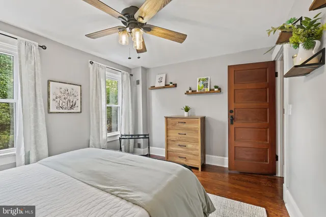 a bedroom with a bed dresser and a window