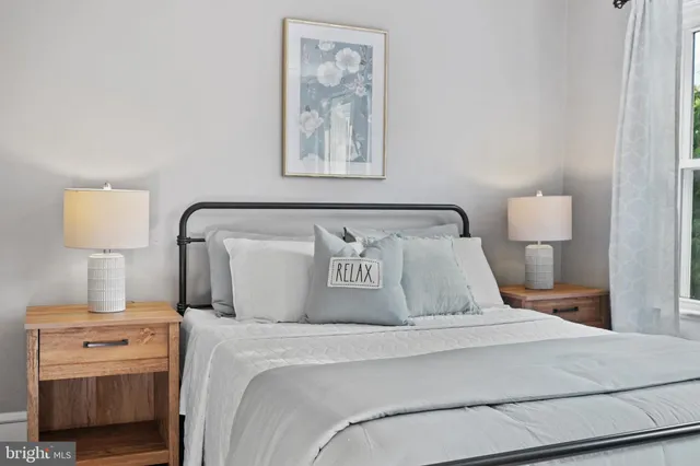 a bedroom with a bed and a lamp on table