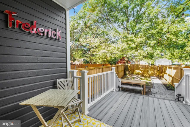 a view of a deck with wooden floor and bench