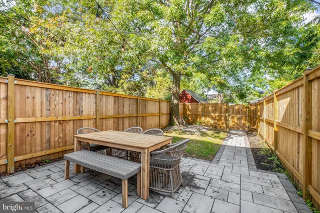 a view of a chairs and table in backyard