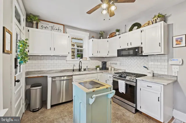 a kitchen with cabinets appliances a sink and a counter top space