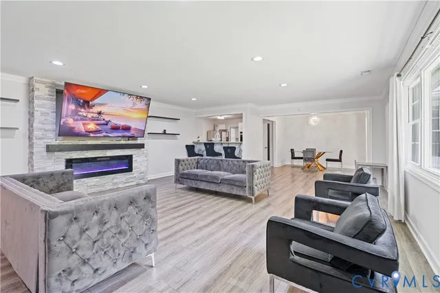 a view of a room with wooden floor lounge chair and windows