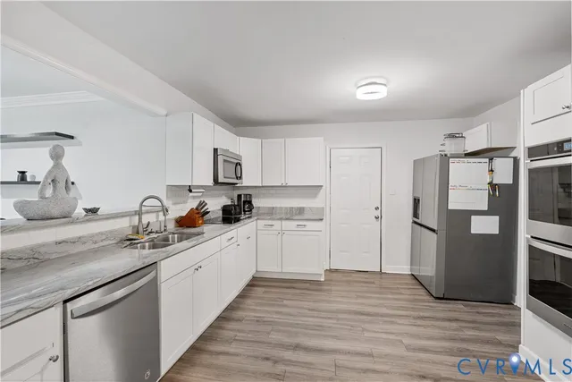 a kitchen with stainless steel appliances a stove microwave and cabinets