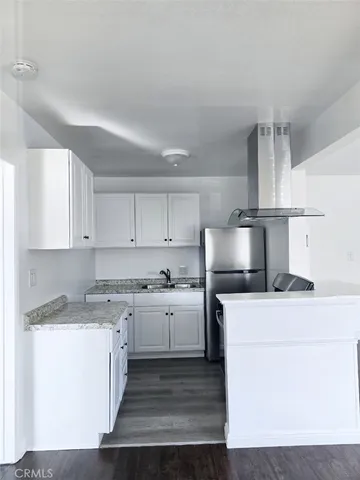 a kitchen with a stove a sink and a refrigerator