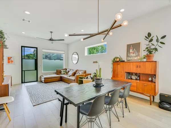 a view of a dining room with furniture and a potted plant