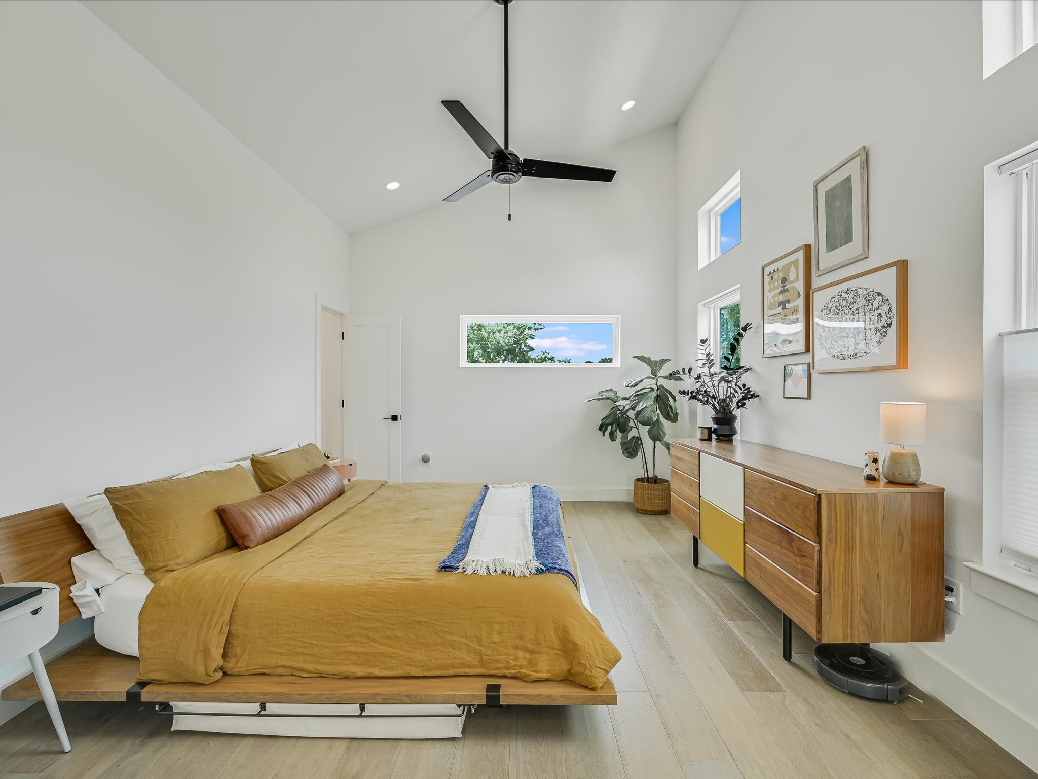 5603 Samuel Huston Avenue, Unit 1 Austin, TX 78721 - Photo 14 of 39 a bedroom with a bed dresser and wooden floor