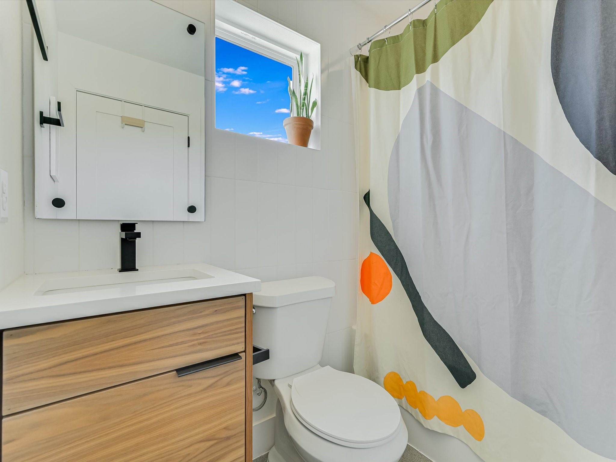 5603 Samuel Huston Avenue, Unit 1 Austin, TX 78721 - Photo 17 of 39 a bathroom with a sink a toilet and shower