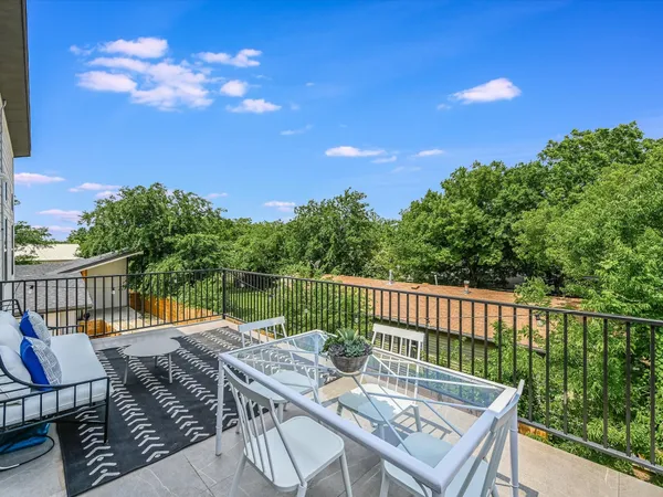 a view of a balcony with two chairs and a table