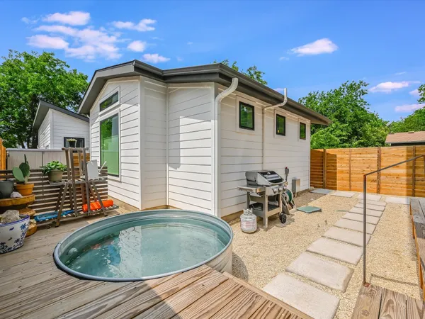 a backyard of a house with yard and outdoor seating