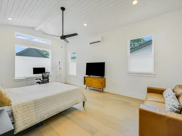 a bedroom with a bed and a flat screen tv