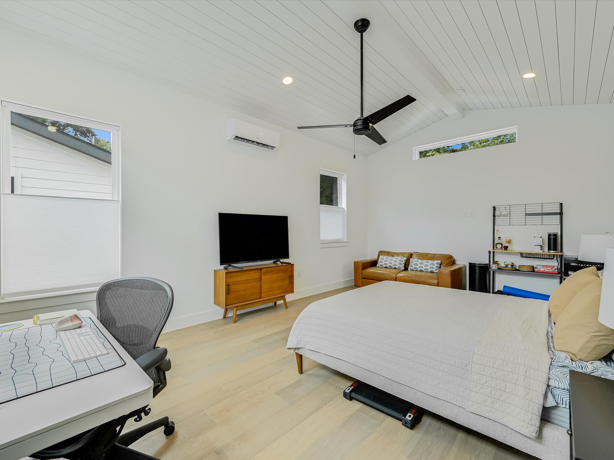 5603 Samuel Huston Avenue, Unit 1 Austin, TX 78721 - Photo 27 of 39 a bedroom with furniture and a flat screen tv