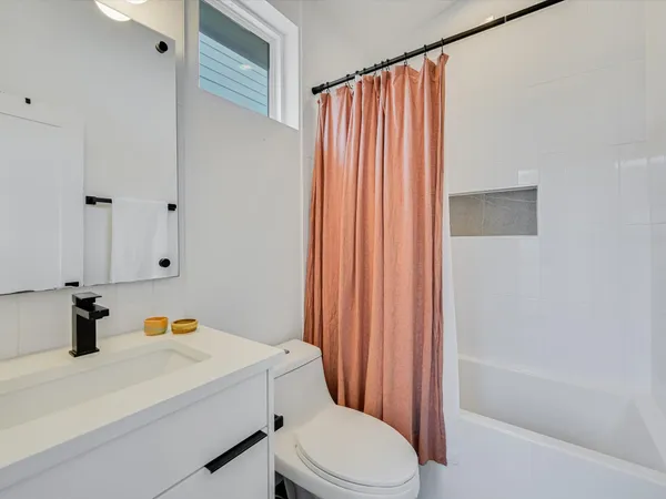a bathroom with a sink toilet and shower