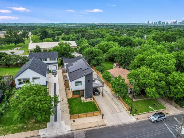 an aerial view of a house with a garden and yard