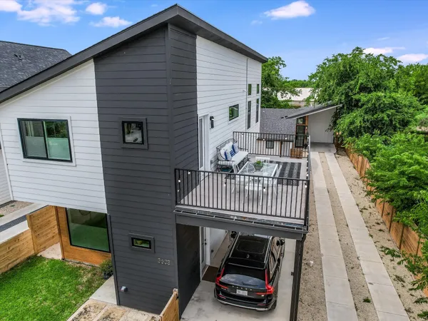a view of a house with wooden deck and furniture