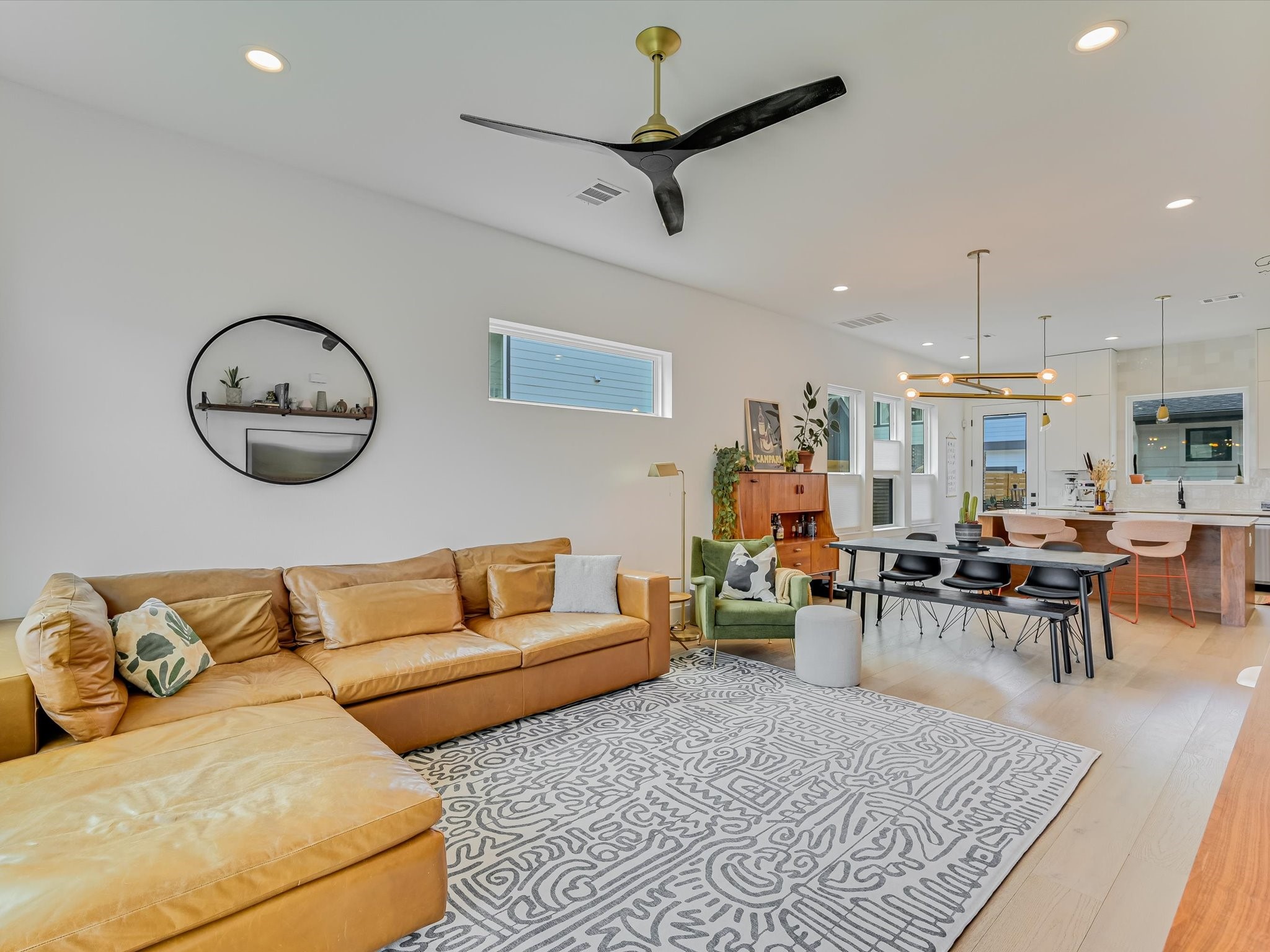 5603 Samuel Huston Avenue, Unit 1 Austin, TX 78721 - Photo 8 of 39 a living room with furniture a rug and a chandelier