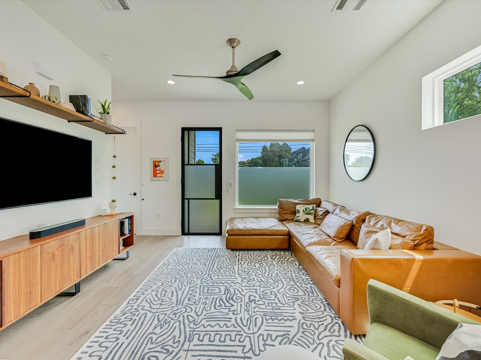 5603 Samuel Huston Avenue, Unit 1 Austin, TX 78721 - Photo 10 of 39 a living room with furniture and a flat screen tv