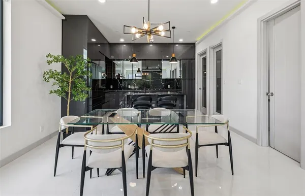 a view of a dining room with furniture and chandelier