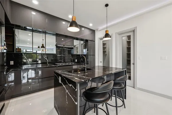 a kitchen with stainless steel appliances kitchen island a large island in the center and cabinets