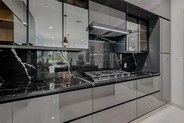a kitchen with stainless steel appliances granite countertop a sink stove and cabinets
